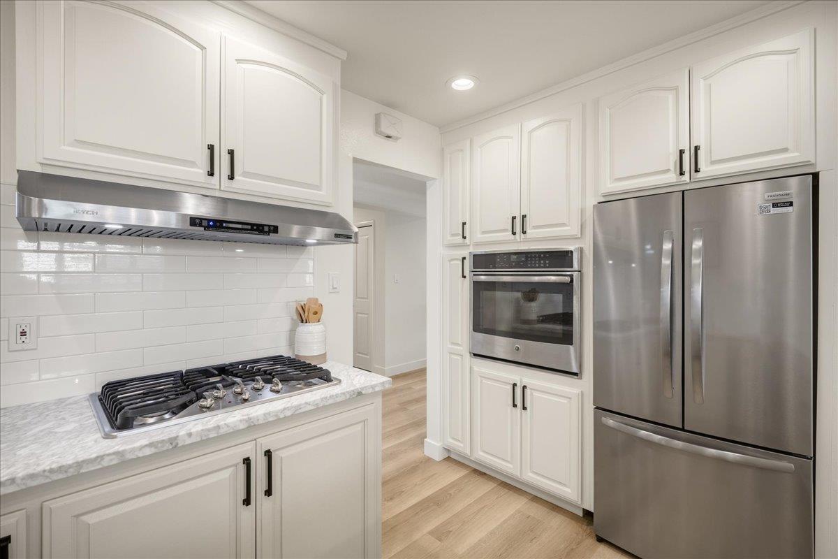 1069 Malott Drive San Jose, CA 95121 - Photo 7 of 32 a kitchen with stainless steel appliances granite countertop a refrigerator and a stove