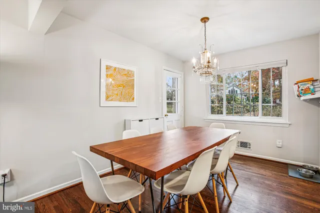 a living room with furniture a rug and a wall painting