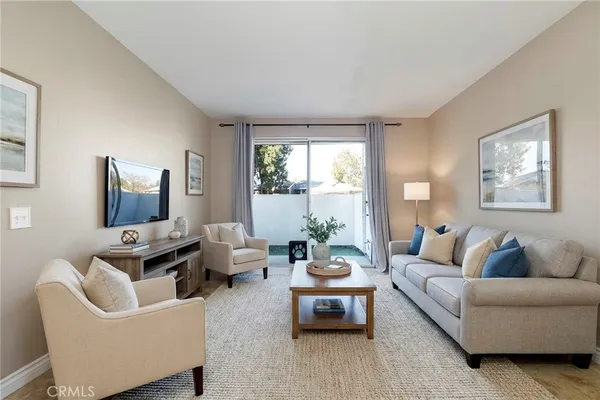 a living room with furniture and a large window