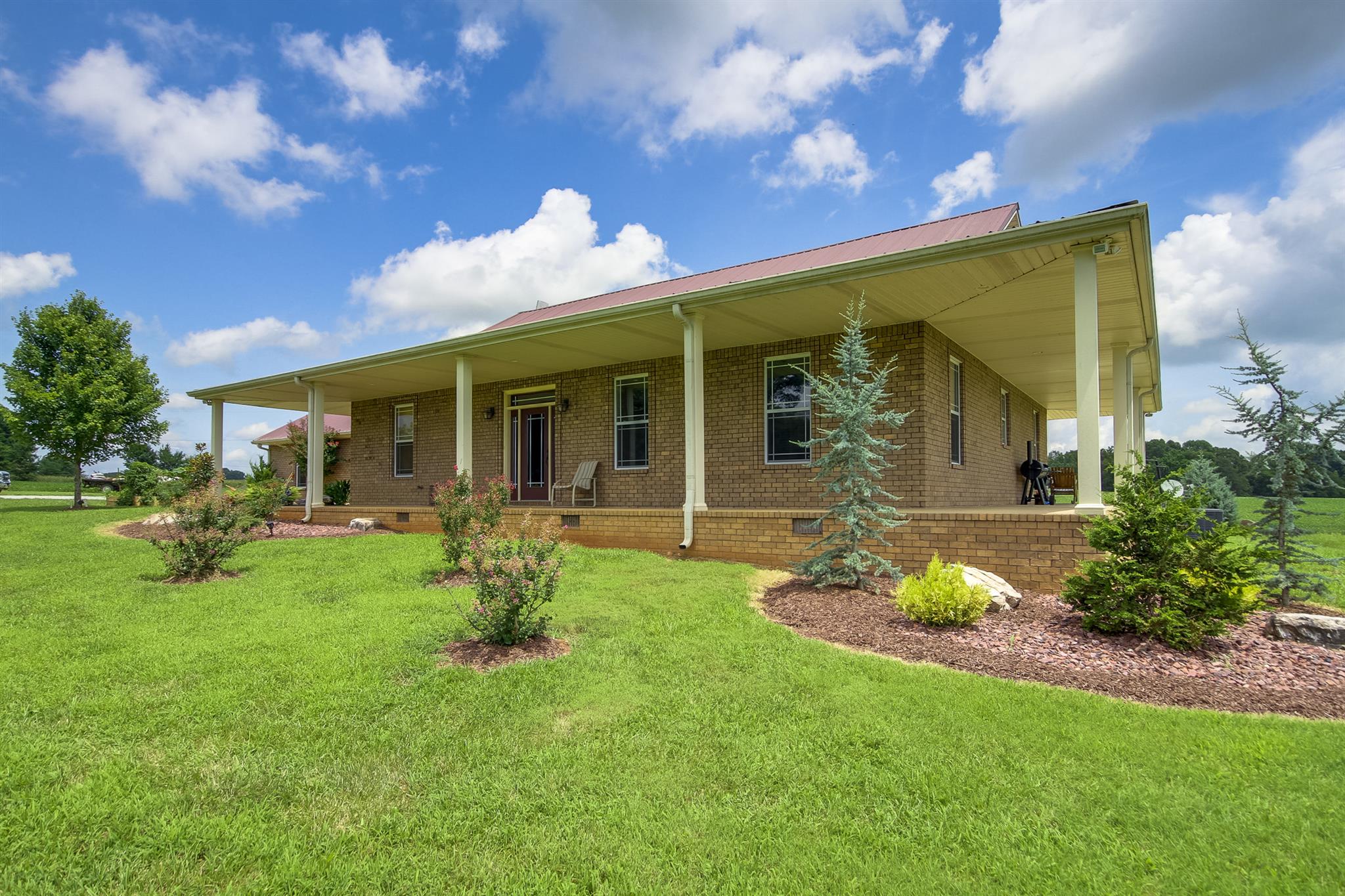 4599 Gamble Road Cedar Hill, TN 37032 - Photo 1 of 25 a front view of a house with garden and patio