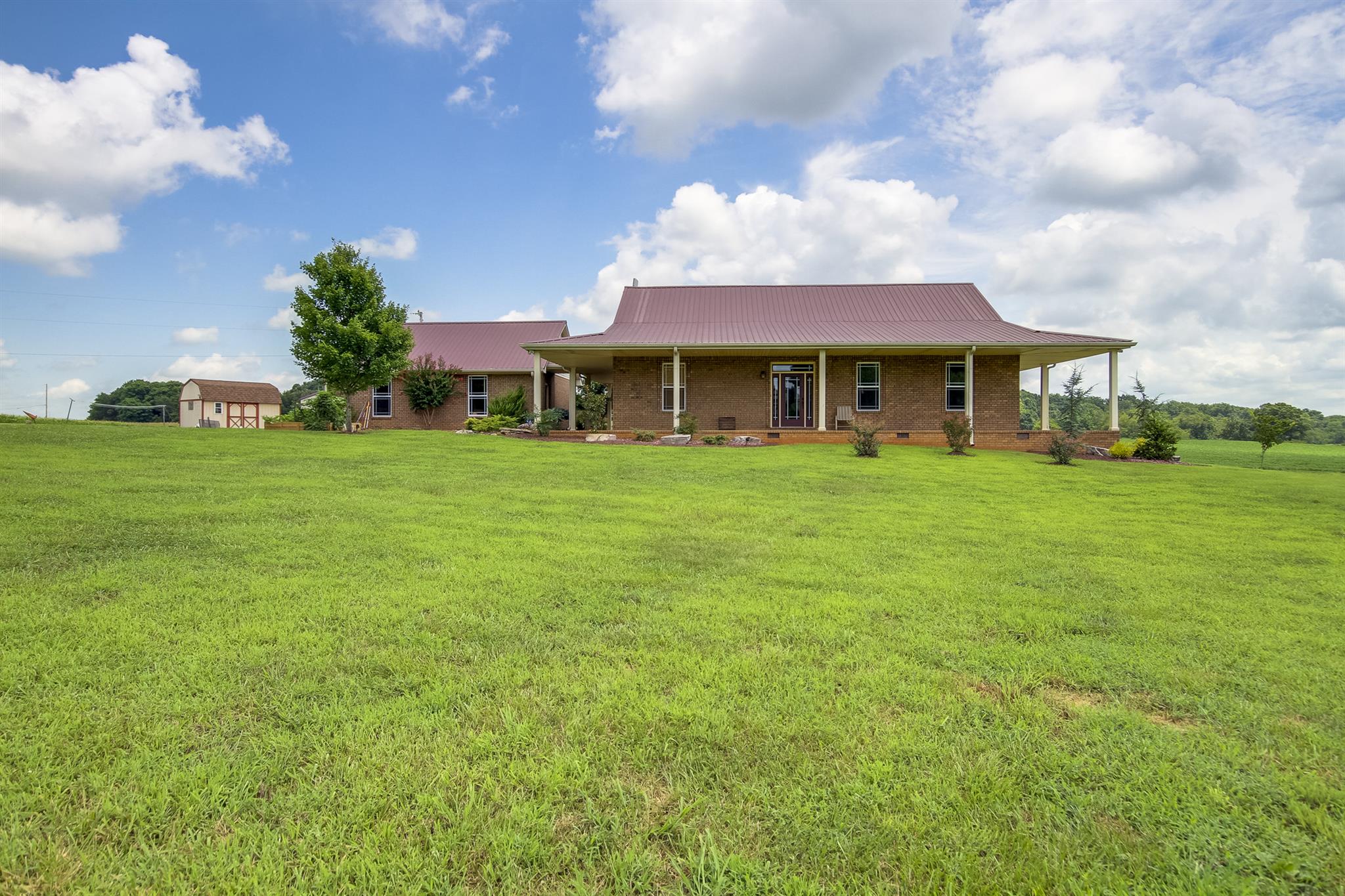 4599 Gamble Road Cedar Hill, TN 37032 - Photo 2 of 25 a view of a house with a big yard and large trees