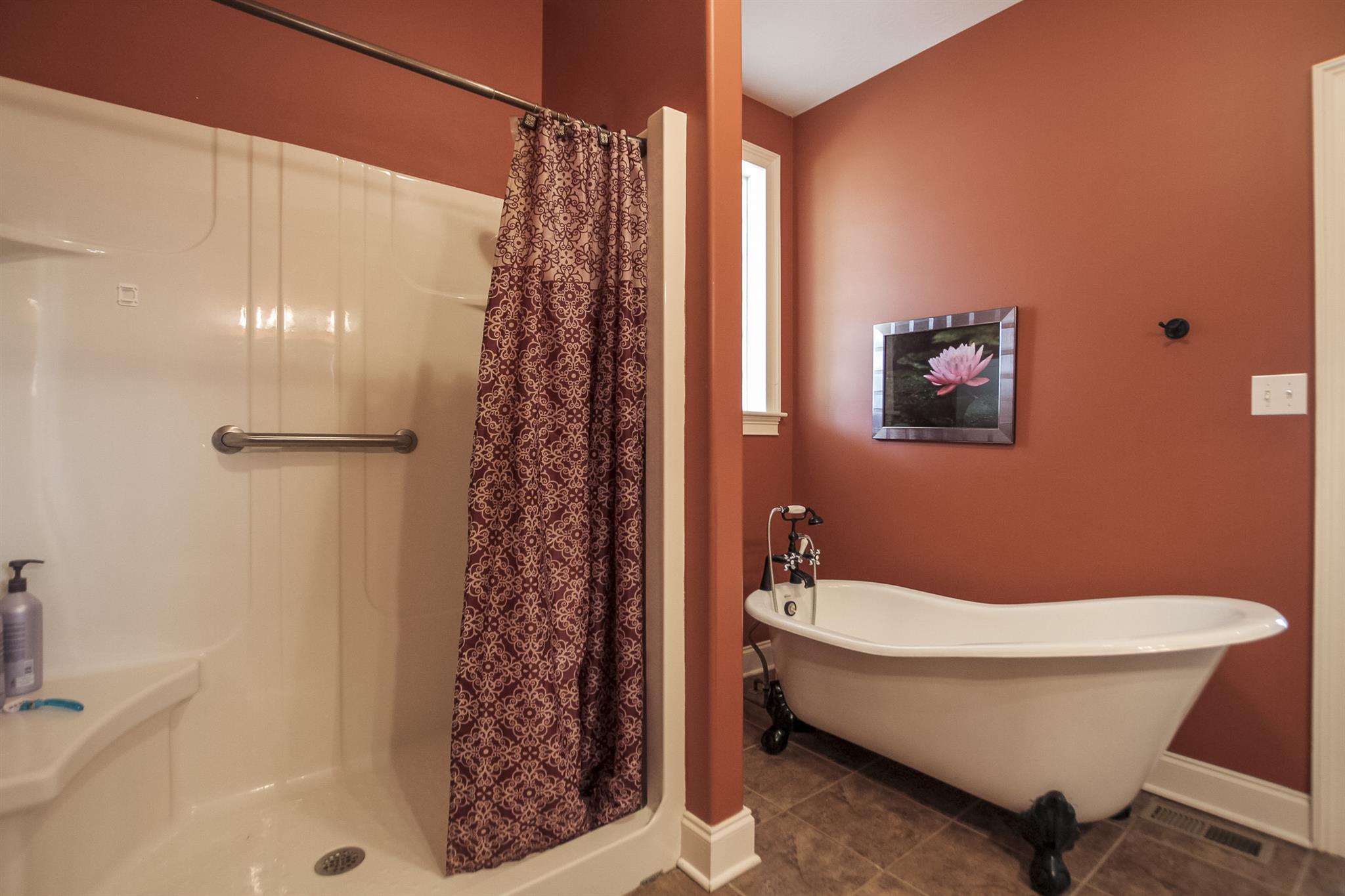 4599 Gamble Road Cedar Hill, TN 37032 - Photo 14 of 25 a bathroom with a bathtub a shower and a sink