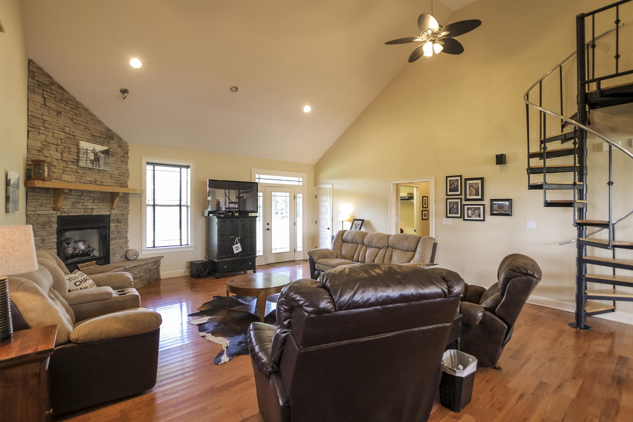 4599 Gamble Road Cedar Hill, TN 37032 - Photo 8 of 25 a living room with furniture a fireplace and a flat screen tv