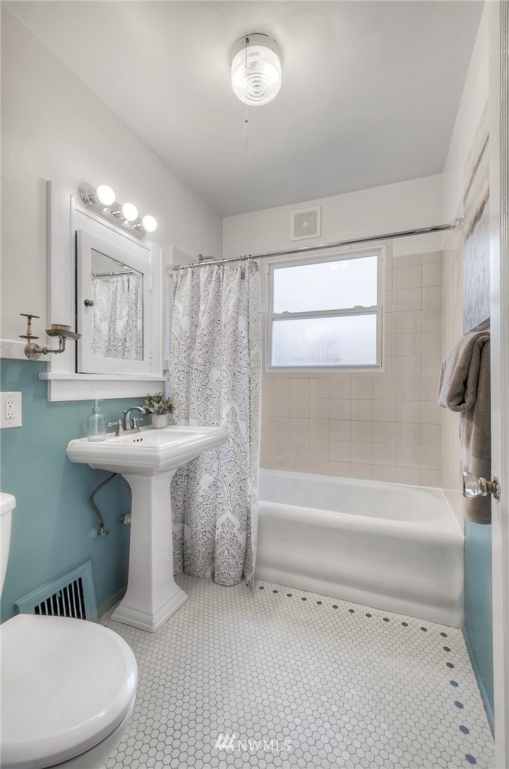 452 North 65th Street Seattle, WA 98103 - Photo 11 of 31 a bathroom with a sink toilet mirror and bathtub