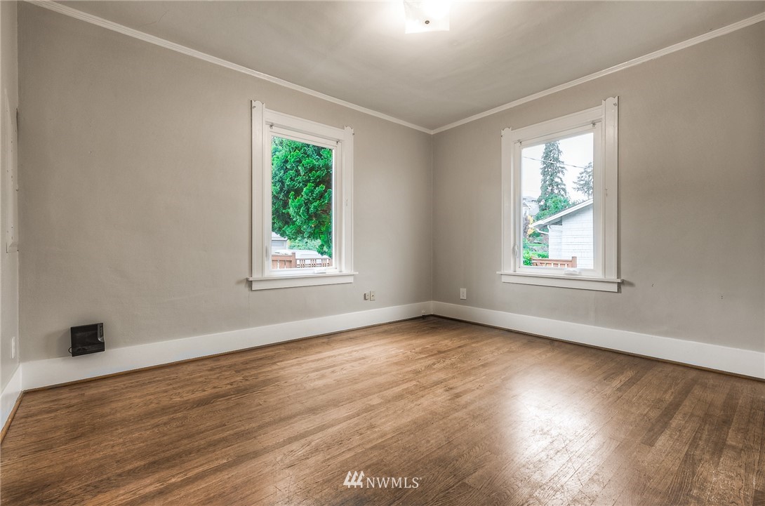 452 North 65th Street Seattle, WA 98103 - Photo 13 of 31 a view of an empty room with wooden floor and a window