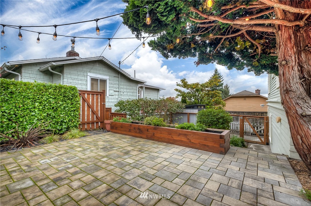 452 North 65th Street Seattle, WA 98103 - Photo 20 of 31 a view of a backyard with plants and a barbeque
