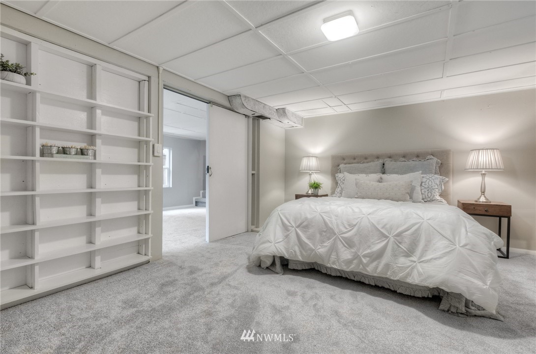 452 North 65th Street Seattle, WA 98103 - Photo 23 of 31 a large bed sitting in a room next to a cabinet