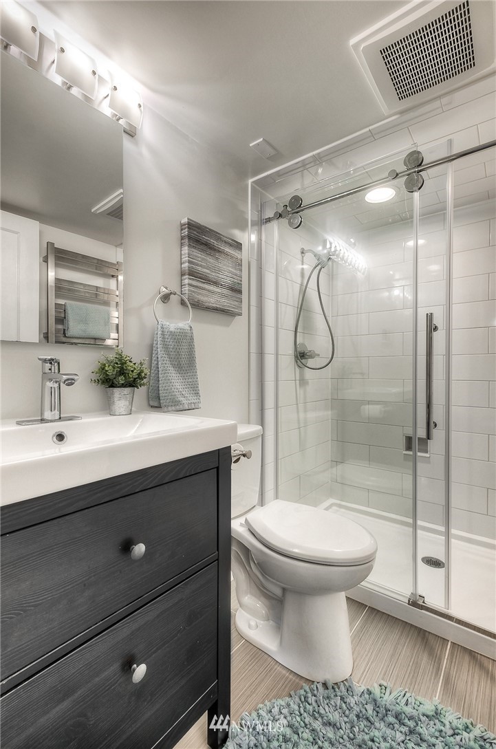 452 North 65th Street Seattle, WA 98103 - Photo 25 of 31 a bathroom with a sink toilet and shower