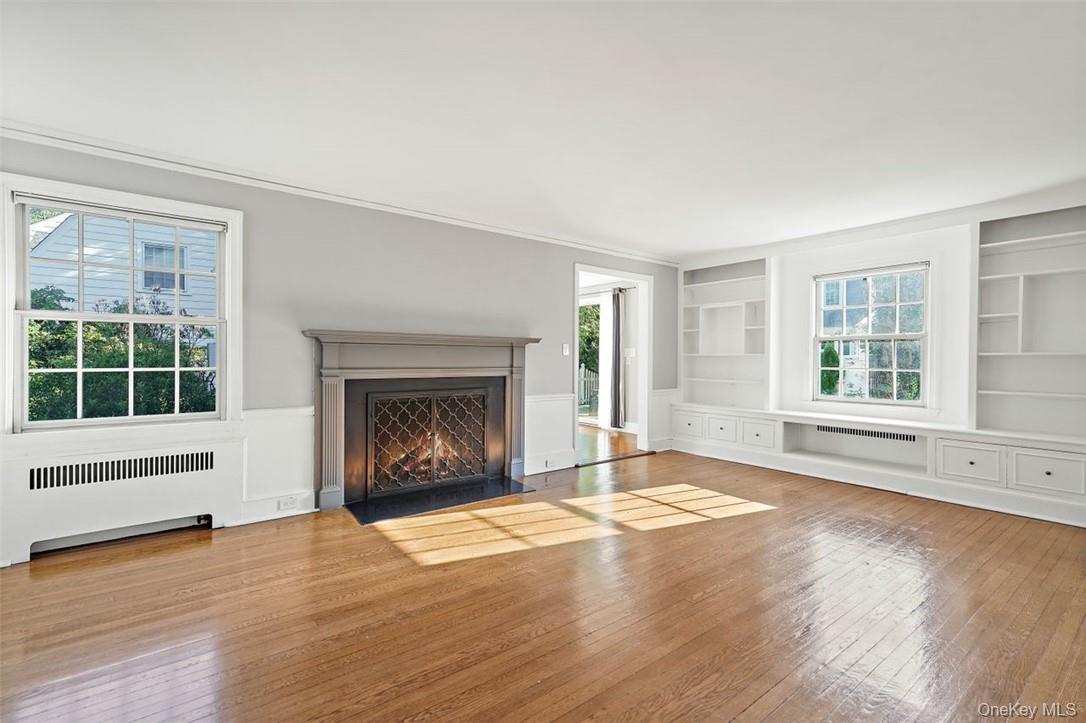 246 Mamaroneck Road Scarsdale, NY 10583 - Photo 3 of 35 Living room with wood burning fireplace and built-ins