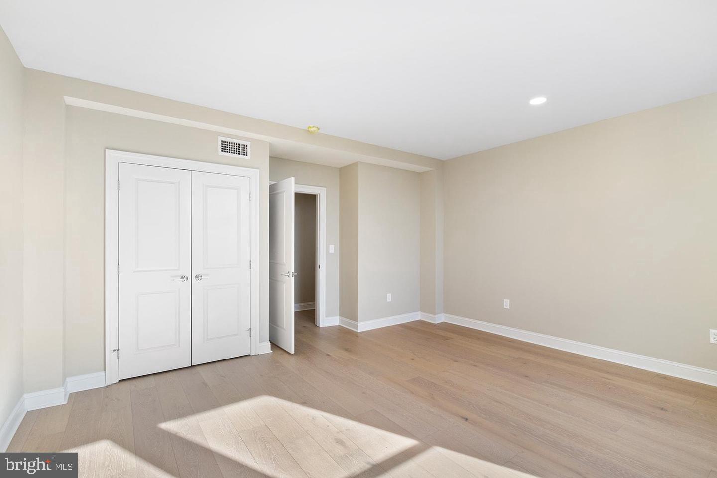 2201 Pennsylvania Avenue, Unit 1204B Philadelphia, PA 19130 - Photo 1 of 46 an empty room with wooden floor and windows