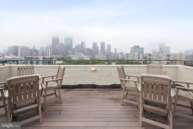 a view of a terrace with wooden benches