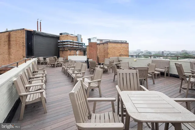 a view of a roof deck with furniture