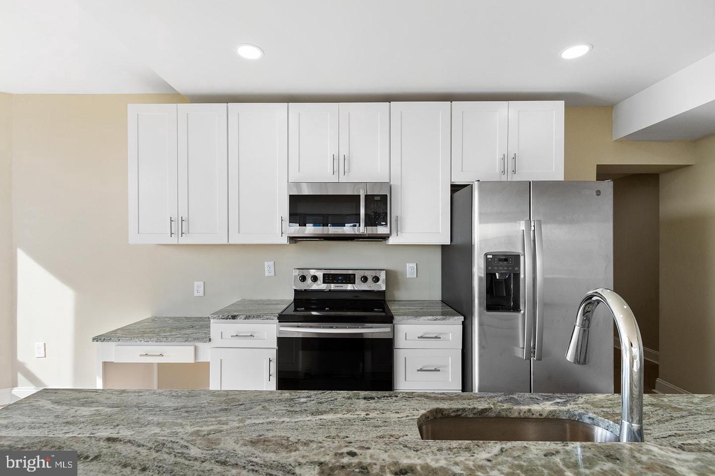 2201 Pennsylvania Avenue, Unit 1204B Philadelphia, PA 19130 - Photo 9 of 46 a kitchen with stainless steel appliances granite countertop a refrigerator a stove and a sink