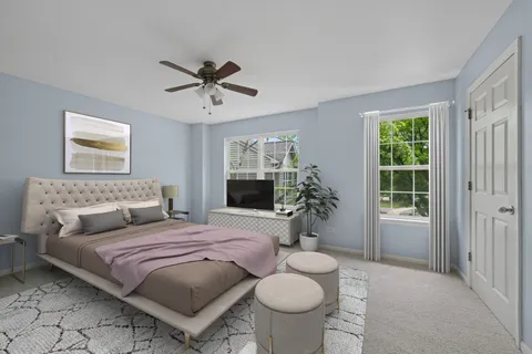 a bedroom with a large bed and a window