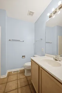 a bathroom with a sink a toilet and a mirror