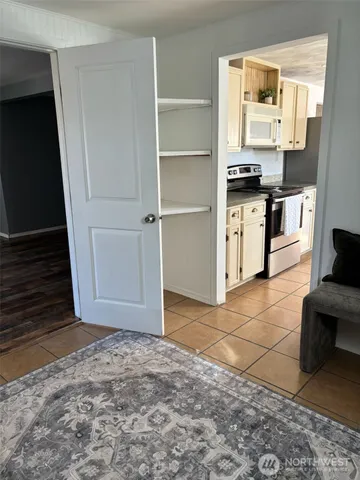a view of kitchen with microwave and cabinets