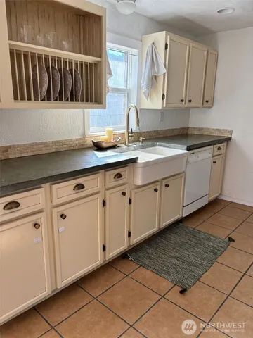 a kitchen with granite countertop white cabinets