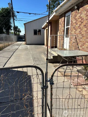 a balcony view with a couple of chairs and potted plants