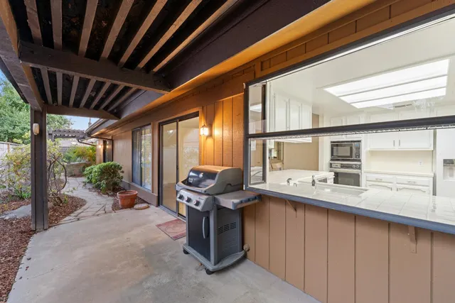 a kitchen with a sink and large window