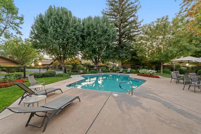 an outdoor space with swimming pool and furniture
