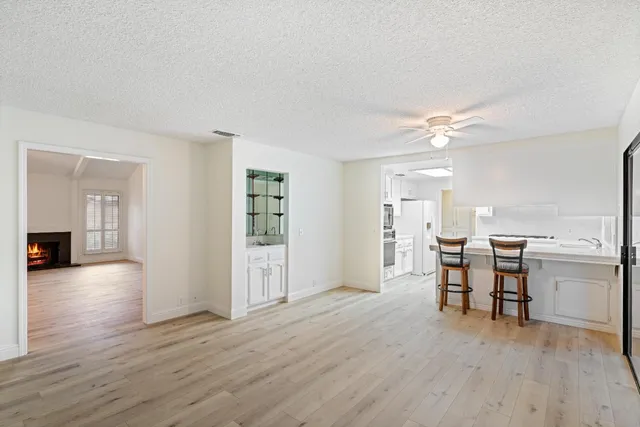 a view of a dining room with furniture and chandelier