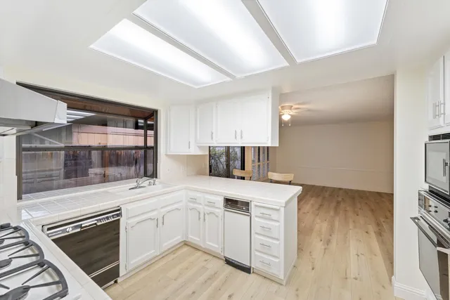 a kitchen with a sink stove and cabinets