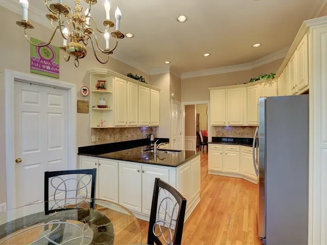 a kitchen with stainless steel appliances granite countertop a sink refrigerator stove and microwave