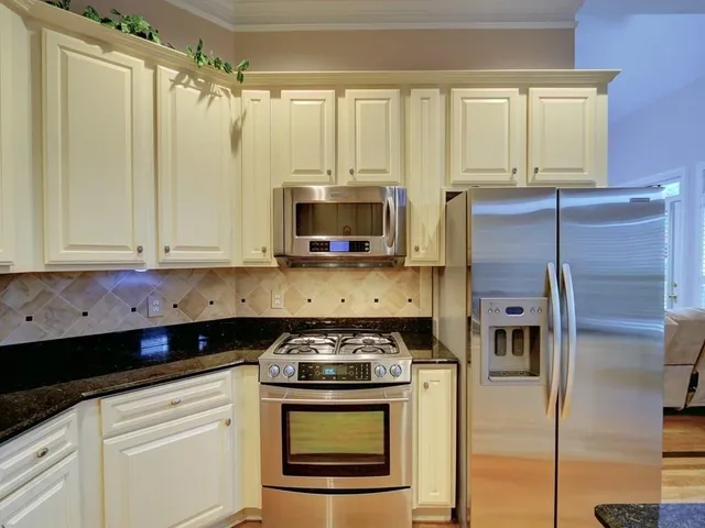 a kitchen with stainless steel appliances a stove a microwave and a refrigerator