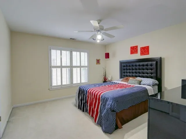 a bed sitting in a bedroom next to a window