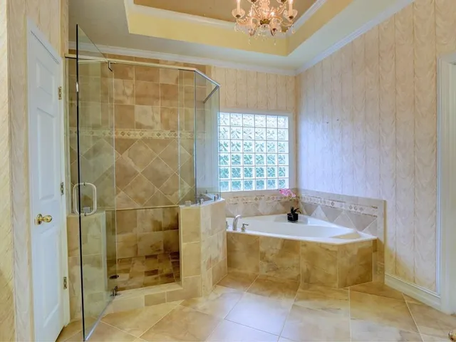 a bathroom with a bathtub and shower