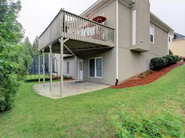 a view of a house with a yard and porch