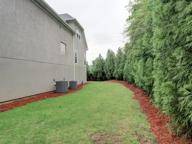 a view of backyard with trampoline