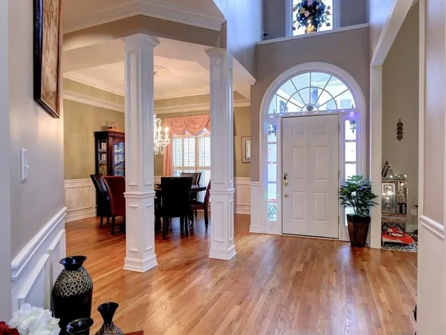 a view of living room and dining room with wooden floor