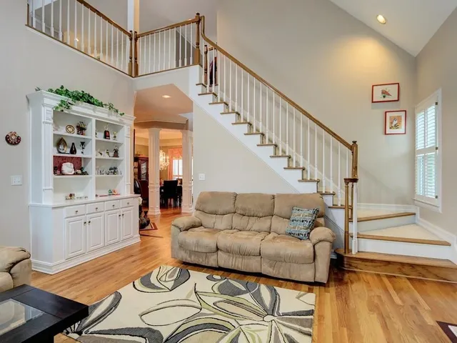 a living room with furniture fireplace and wooden floor