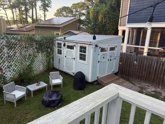 a view of a patio with table and chairs with wooden fence and plants