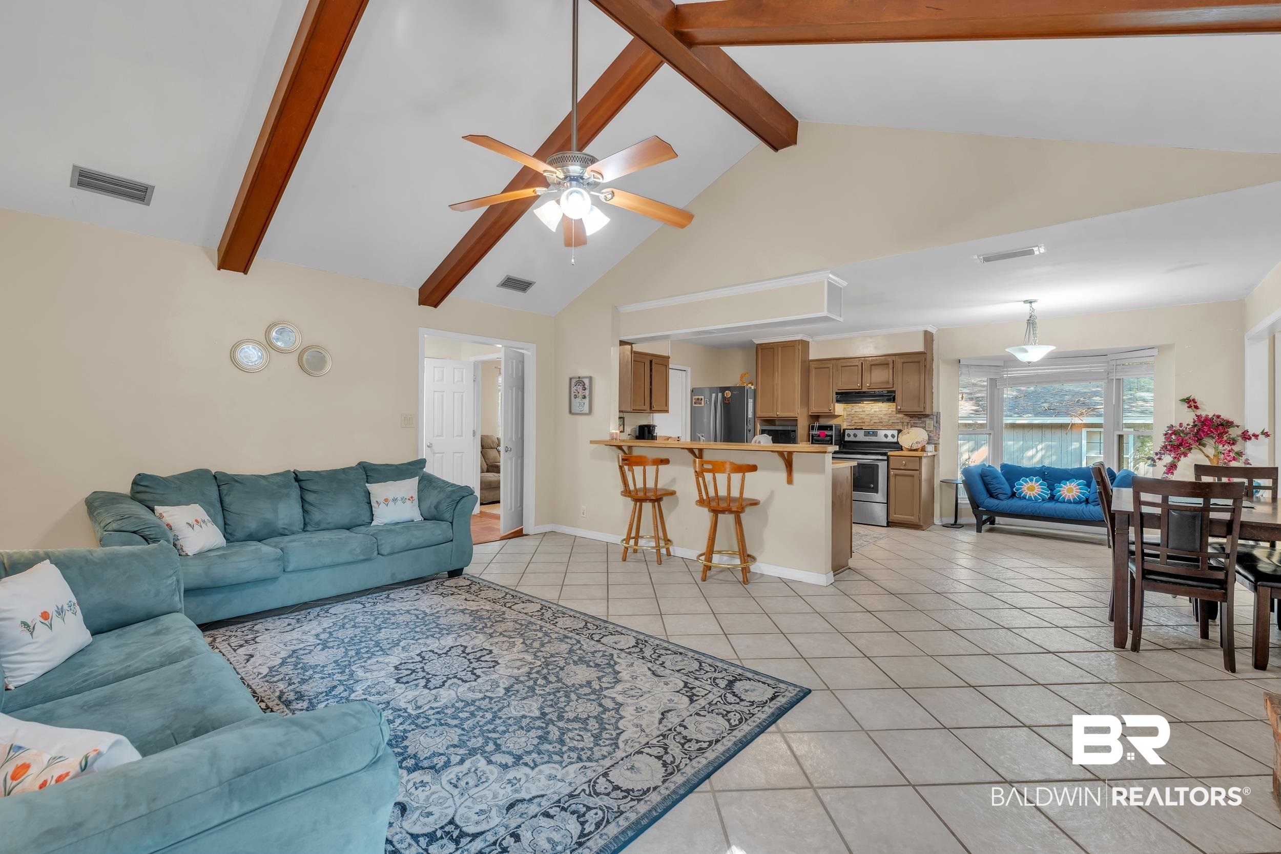130 Chatam Loop Daphne, AL 36526 - Photo 5 of 26 Living area featuring light tile patterned flooring, a ceiling fan, high vaulted ceiling, and beam ceiling