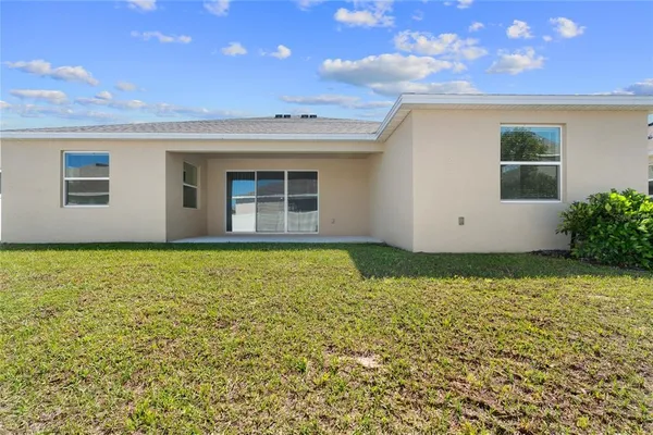 a view of an house with backyard space and garden