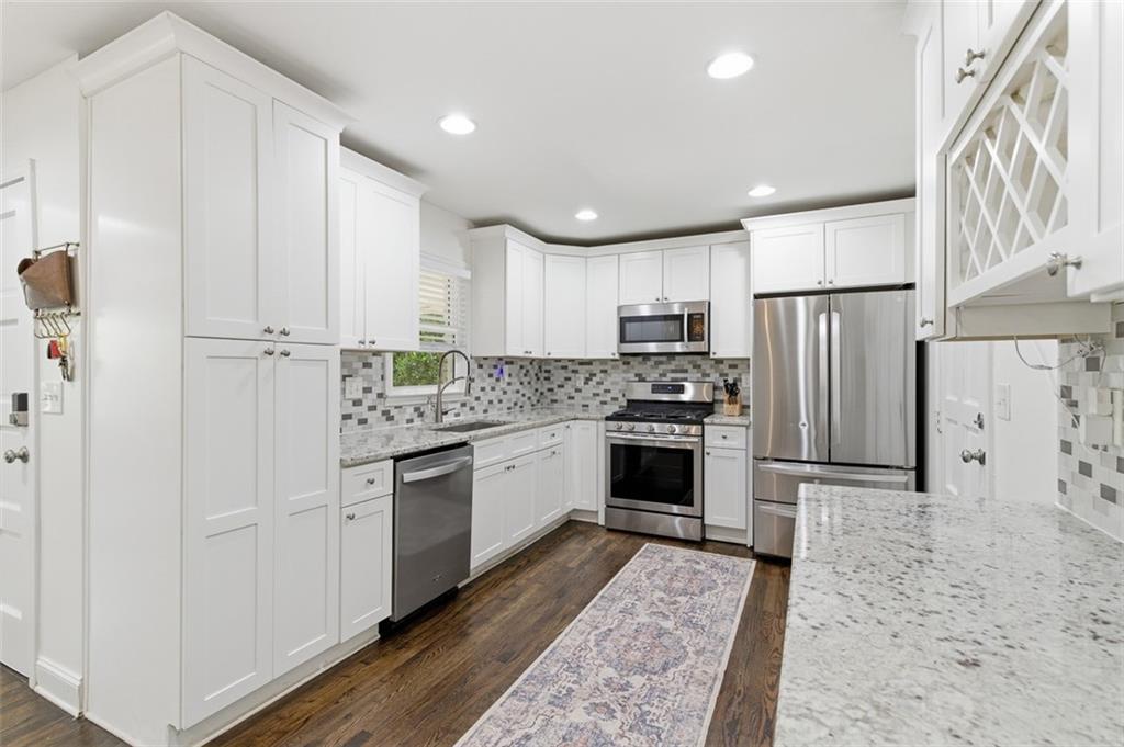3180 Rehoboth Drive Decatur, GA 30033 - Photo 14 of 36 a kitchen with stainless steel appliances granite countertop a refrigerator sink and cabinets