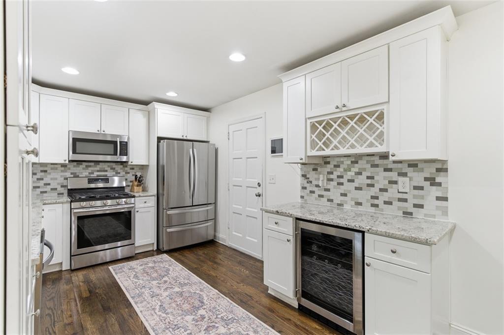 3180 Rehoboth Drive Decatur, GA 30033 - Photo 15 of 36 a kitchen with granite countertop cabinets stainless steel appliances and wooden floor