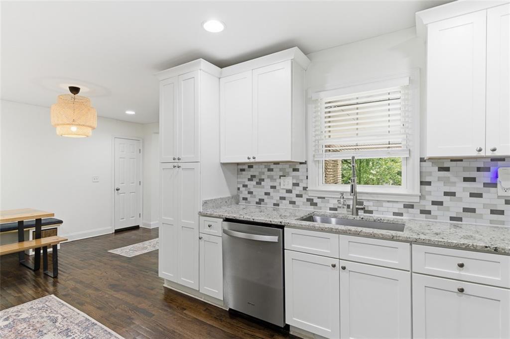 3180 Rehoboth Drive Decatur, GA 30033 - Photo 16 of 36 a kitchen with granite countertop white cabinets and white appliances