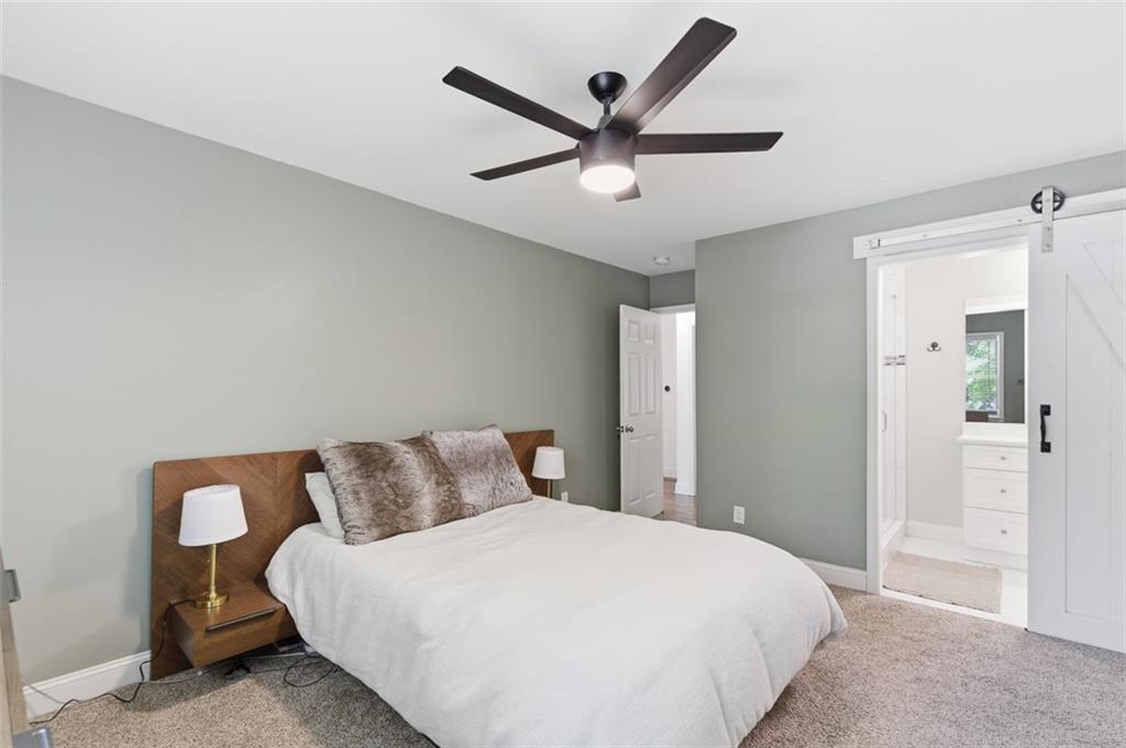3180 Rehoboth Drive Decatur, GA 30033 - Photo 22 of 36 a bedroom with a large bed and a ceiling fan