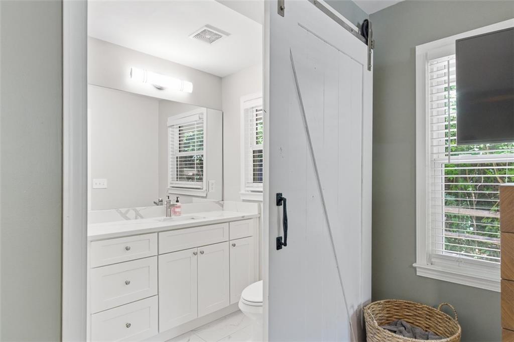 3180 Rehoboth Drive Decatur, GA 30033 - Photo 23 of 36 a bathroom with a sink a toilet and a mirror