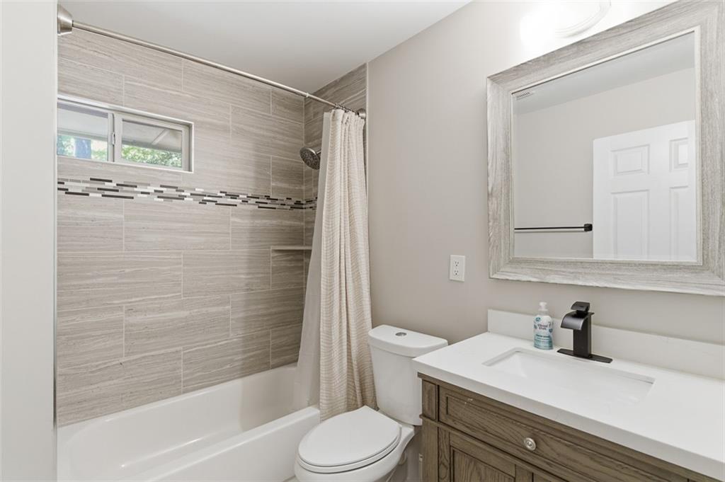 3180 Rehoboth Drive Decatur, GA 30033 - Photo 30 of 36 a bathroom with a granite countertop sink toilet a mirror and shower