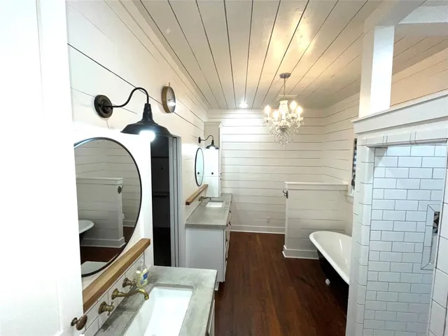 a bathroom with a sink a mirror and shower