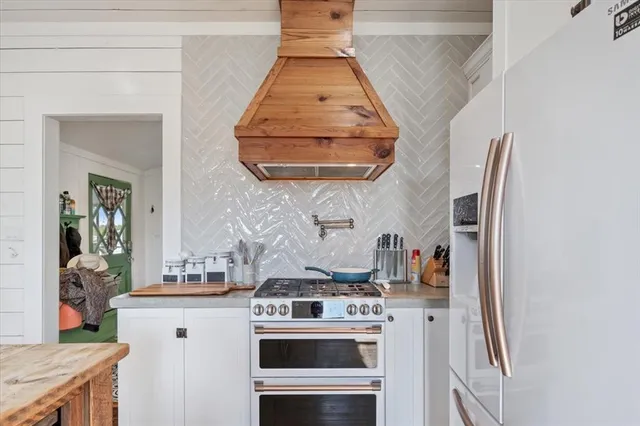 a kitchen with a stove and a white cabinet