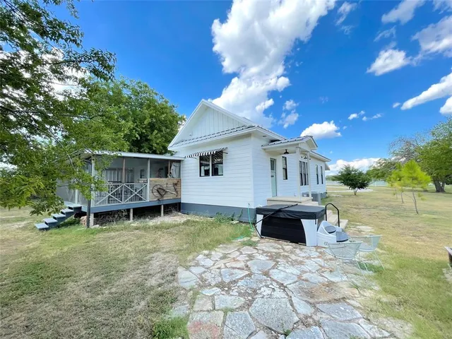 a view of a house with backyard and sitting area