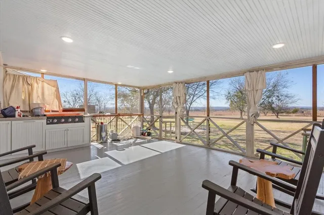 a room with lots of furniture and a large window