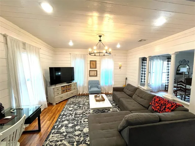 a living room with furniture and a flat screen tv