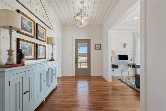 a hallway with fireplace and wooden floor
