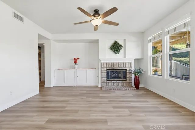 a large kitchen with stainless steel appliances kitchen island a large counter top and a refrigerator